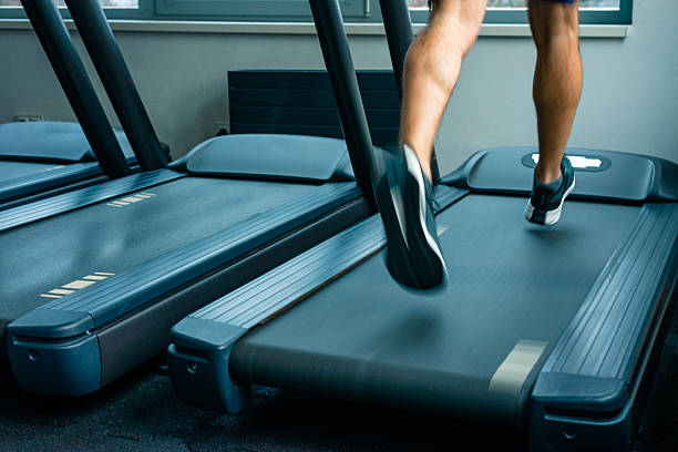 istock Close up of legs running on treadmill 2253361028
