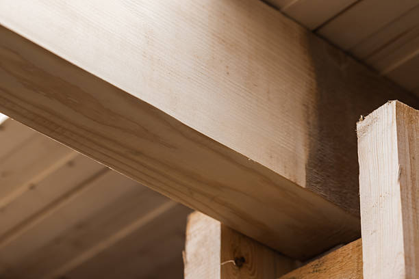 istock Warm, natural wood construction scene featuring intersecting beams 2253364549
