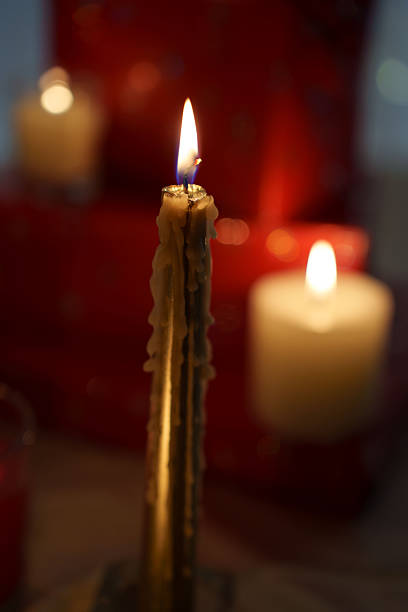 Four burning candles close up. High angle view.