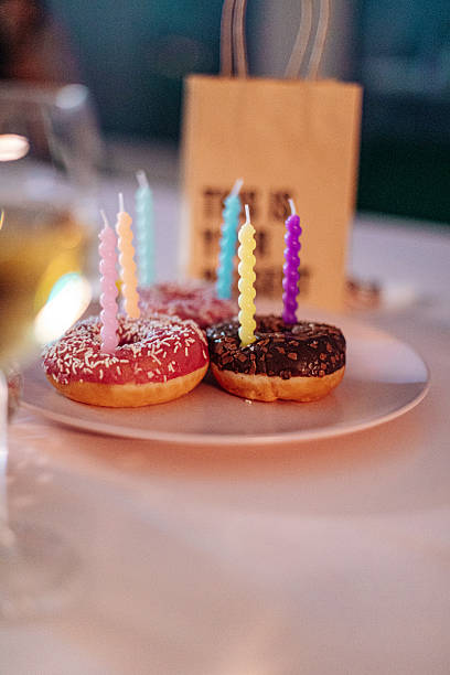 Birthday donuts with colorful candles on a plate, ready for celebration