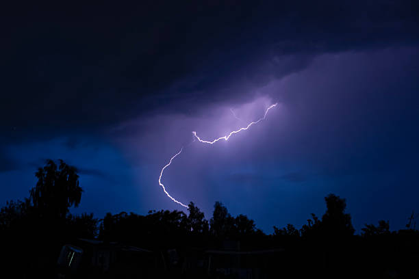 istock beautiful lightning during a thunderstorm at night in a forest that caused a fire, against a dark sky with rain 2253368189