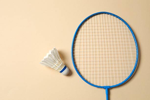 istock Badminton racket and white badminton shuttlecock on color background 2253369827