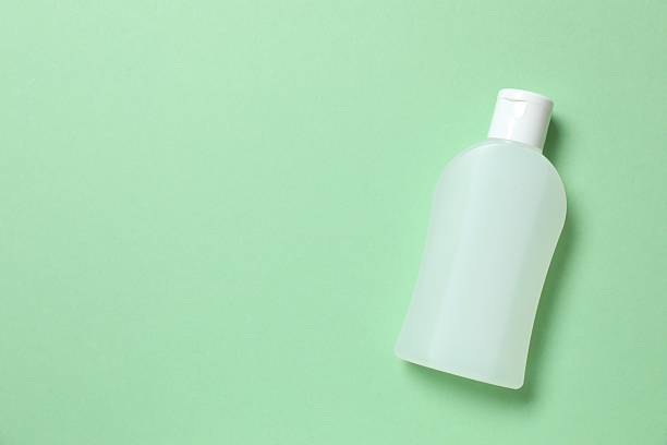 istock Natural cosmetic bottle on green background, top view 2253369878