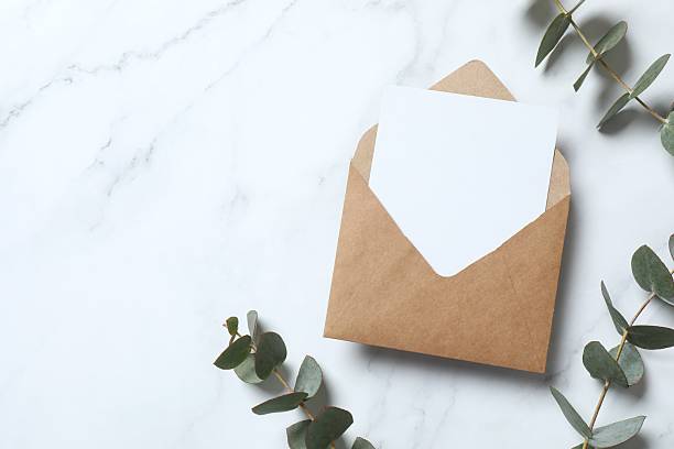 istock Romantic flat lay witn paper envelope, blank card, eucalyptus branches on marble. Ideal for wedding invitations, event announcements, or feminine branding 2253369927