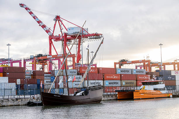 Rotterdam, The Netherlands: March 06, 2024: Large gantry cranes and container ship - port of Rotterdam - Maasvlakte. The Maasvlakte is a massive westward extension of the Europoort port and industrial facility within the Port of Rotterdam.