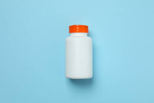 istock Medicine bottle on blue background 2253370302