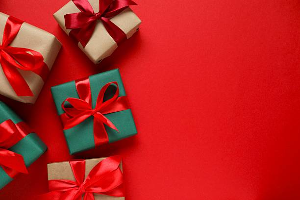 istock Beautiful Christmas gift boxes tied with bows on color background 2253370665