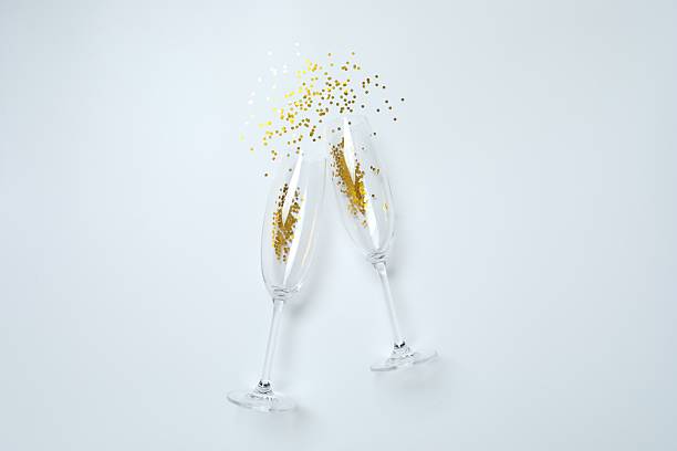 istock Festive background with champagne glasses and confetti 2253370773