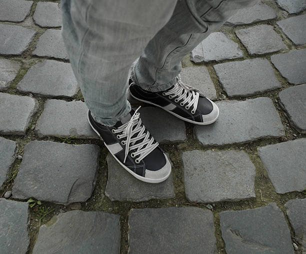 istock sneakers on the cobblestone pavement. 2253370997