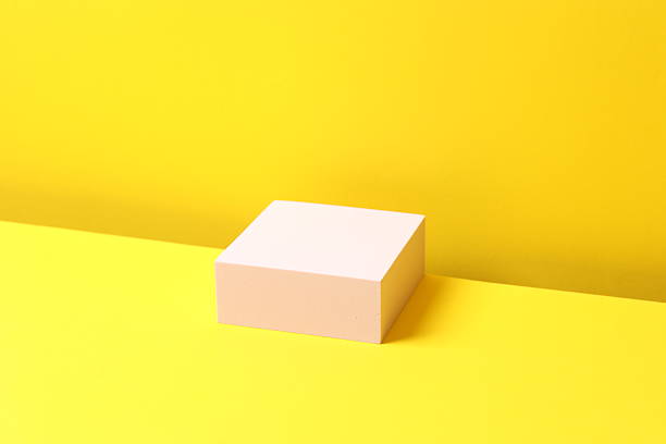 istock Pink podium on a yellow background 2253372504