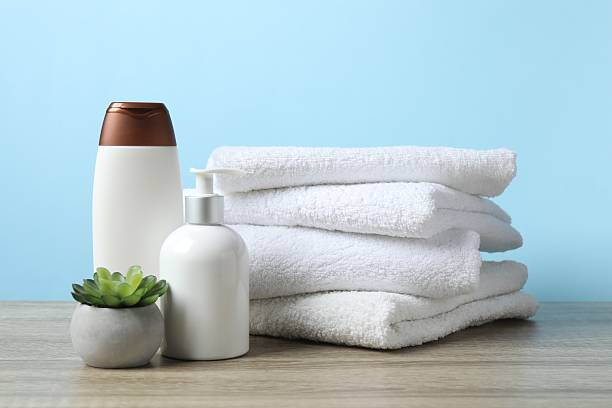 istock Stack of white towels and cosmetics on the table 2253374541