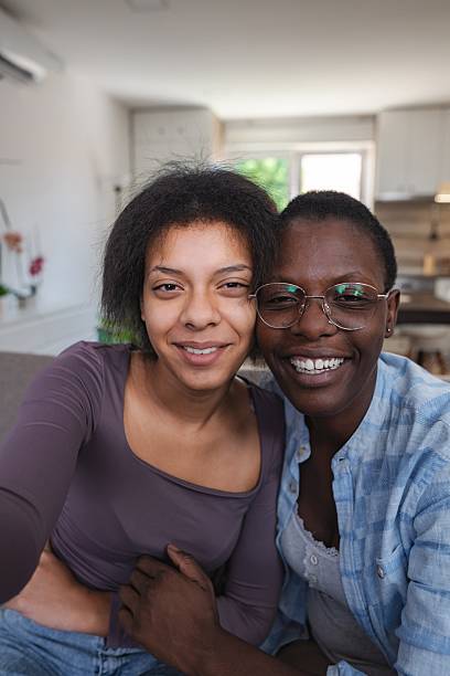 istock Two Young Women Embracing on the Sofa at Home 2253374991