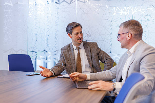 istock Business professionals discussing work at modern office meeting 2253375454