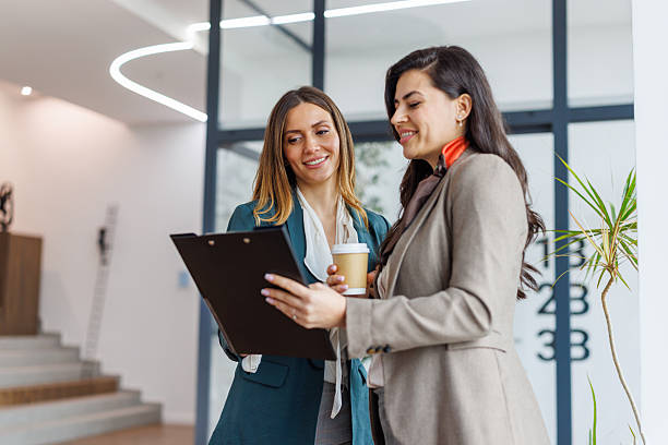 istock Businesswomen discussing project in modern office hallway 2253375502
