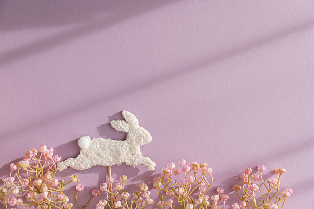 Easter Bunny Stick and Pastel Flowers on Purple Background