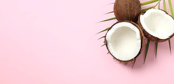 istock Coconut with leaves on pink background, top view 2253376210