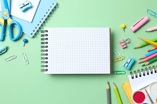 istock School supplies including notebook, pencils and stationery on green background 2253376585