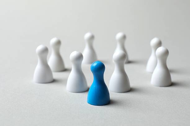 istock Group of colored pawns on the table. Concept of unity 2253376970
