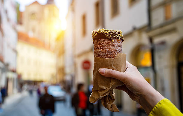istock Traditional Czech trdelnik with blurred Prague background. 2253377227