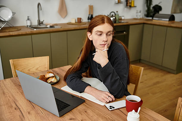 istock Thoughtful young man reflects at home while enjoying coffee and pastries in cozy kitchen setting 2253377422