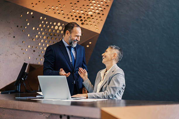 istock Business colleagues collaborating and laughing in modern office 2253378659
