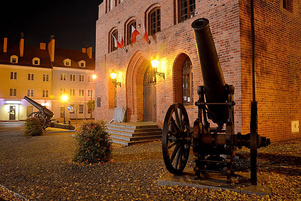 A Warmian town at night in Poland with historic cannons