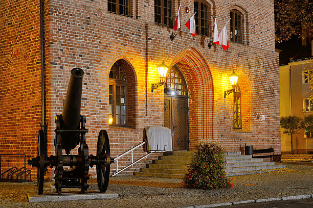 A Warmian town at night in Poland with historic cannons
