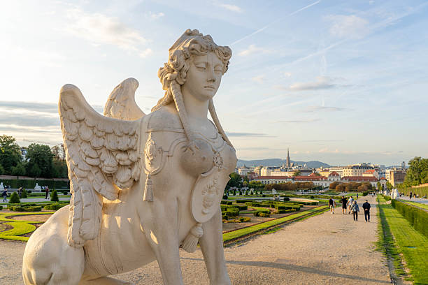 Vienna, Austria - April 25, 2024 : Sphinx sculpture in front of baroque Upper Belvedere palace