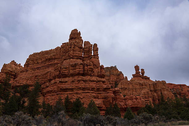 Red Canyon, near of Bryce Canyon National Park, explodes with a fiery symphony of color. Unlike its more famous neighbor, Red Canyon offers a subtler, yet equally captivating, beauty. Imagine towering cliffs and hoodoos, sculpted by eons of wind and water, ablaze in a palette of reds that range from deep crimson to delicate rose. The sunlight dances on these rock formations, setting them ablaze with an ever-shifting play of light and shadow.