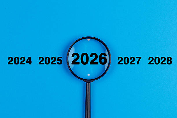 istock Magnifying glass new year 2026 on blue background. Search concept. 2253383858