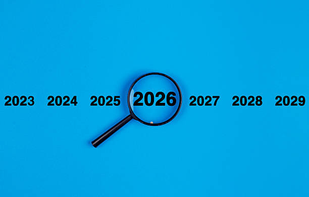 istock Magnifying glass new year 2026 on blue background. Search concept. 2253384025