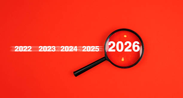 istock Magnifying glass new year 2026 on red background. 2253384561