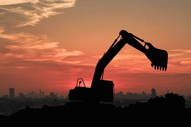 istock Crawler excavators silhouette are digging the soil in the construction site 2253386613