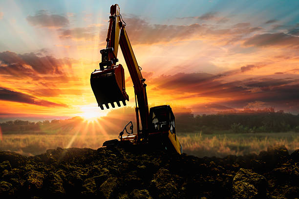 istock Crawler excavators silhouette are digging the soil 2253386675
