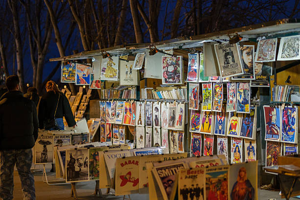 Paris, France - December 10, 2025 : View of a traditional open-air bookshop, the famous bouquinistes of Paris France at night