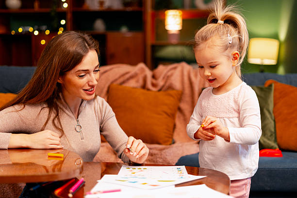 Mother and daughter enjoying an art activity at home, engaging in creative learning and bonding