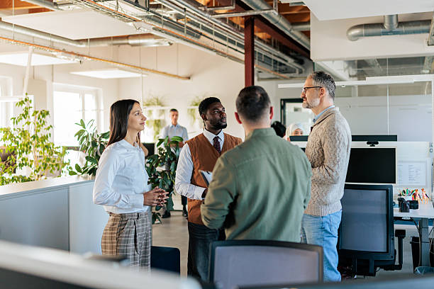 istock Diverse Colleagues Communicating in an Open Office 2253388684