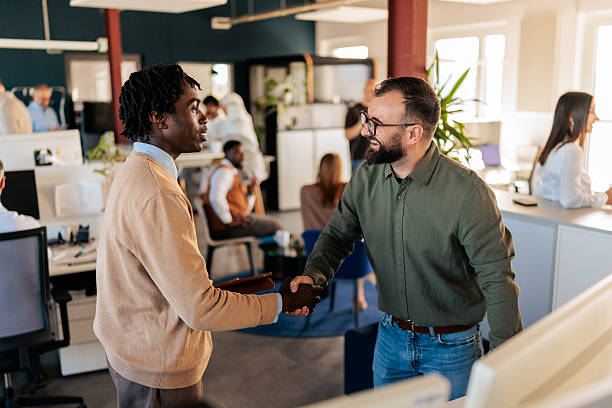 istock Business Colleagues Shaking Hands in a Modern Office 2253389202