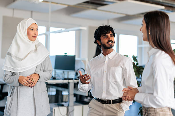 istock Diverse Coworkers Talking Together in a Modern Office 2253389889