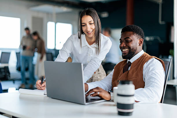 istock Colleagues Working Together on a Laptop in the Office 2253390865
