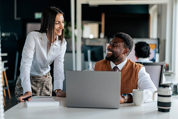 istock Coworkers Collaborating at a Desk in a Modern Office 2253390888