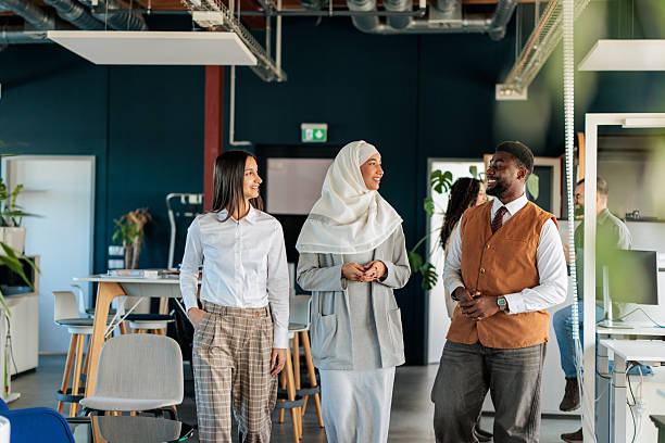 istock Diverse Coworkers Walking and Talking in a Modern Office 2253390959
