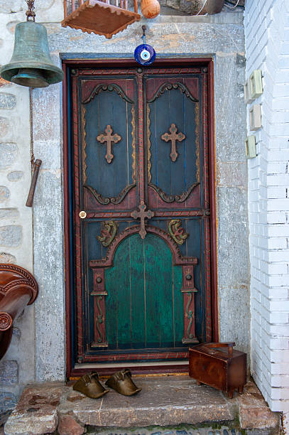 Old wooden door with religious cross on it.