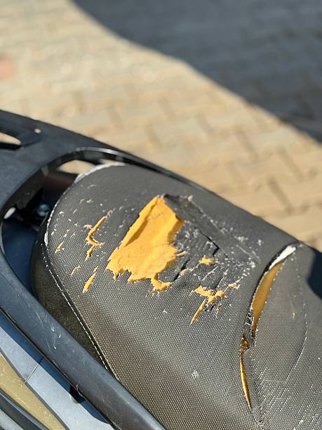 istock Ripped motorcycle seat with visible damage and exposed foam, suitable for background use 2253392332