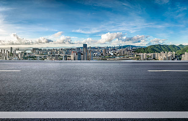 istock Empty asphalt road and modern city skyline with blue sky. 2253392792