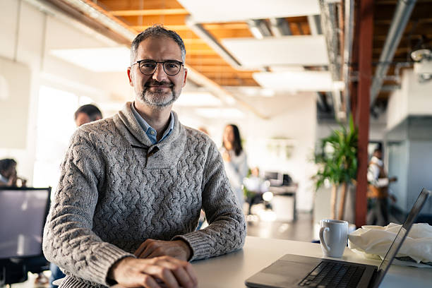 istock Confident Business Professional Sitting at Desk in Modern Office 2253393309