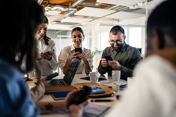 istock Colleagues Using Smartphones Together at the Office 2253393431