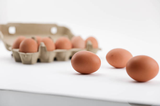 Brown Chicken Eggs Arranged In Open Egg Carton And Placed On Clean White Background, Representing Fresh Food, Organic Nutrition, Farm Product, Natural Protein Source, Minimalist Still Life, And Studio Food Photography.