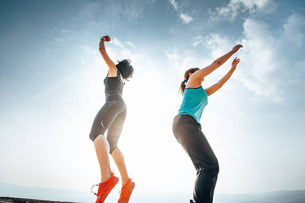 asian woman jumping against the sky