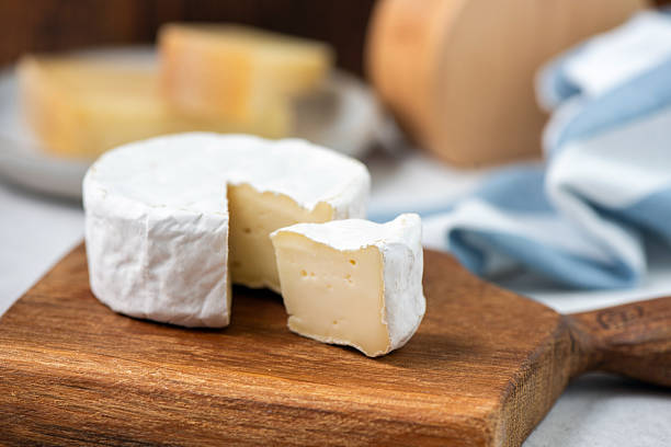 istock Camembert, brie cheese on wooden board 2253398227